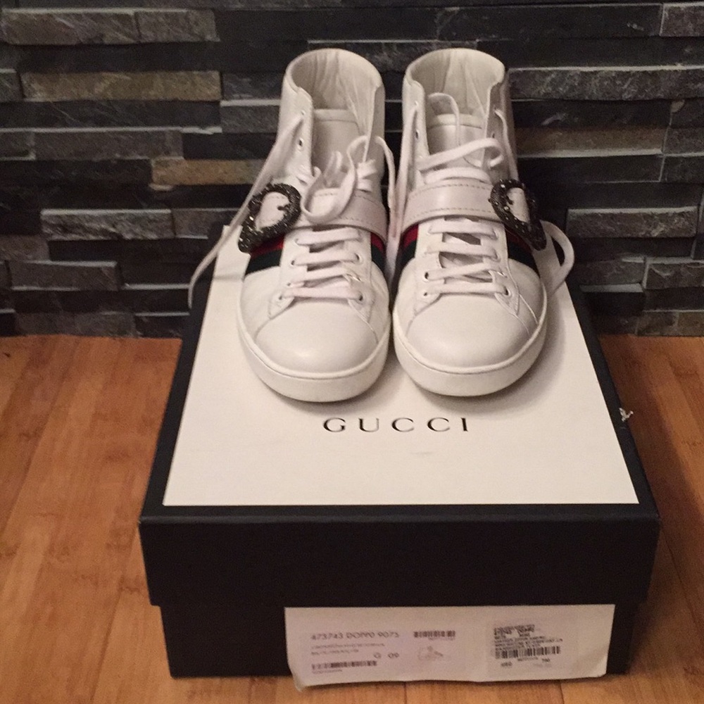 White leather Gucci sneaker w/ metal snake buckle.